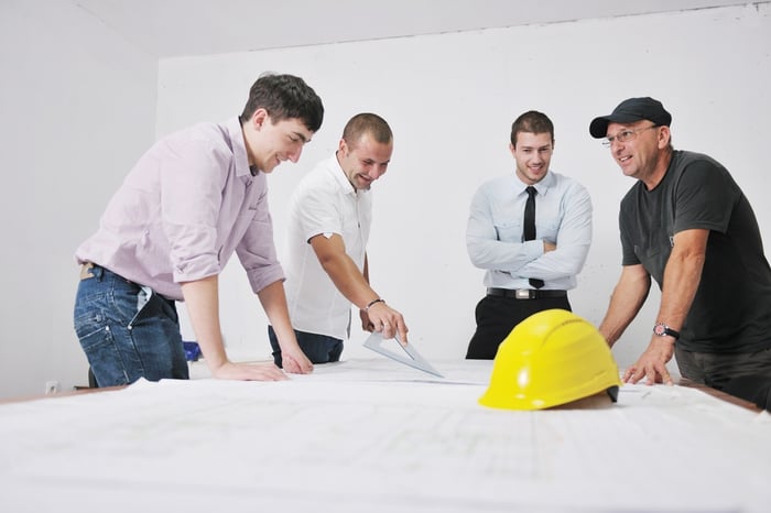  architect and engineer on construction site check documents and workflow